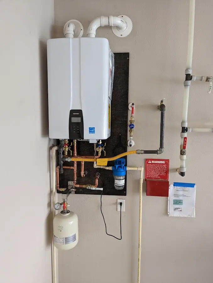 Professional plumber installing copper piping in a Sanger home